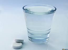Picture of glass of water and 2 pills